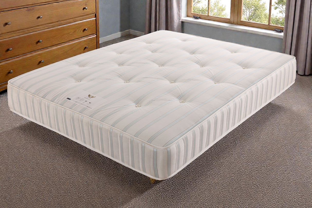 Jamie divan bed set with tall button-tufted headboard and footboard, shown in a modern bedroom setting.