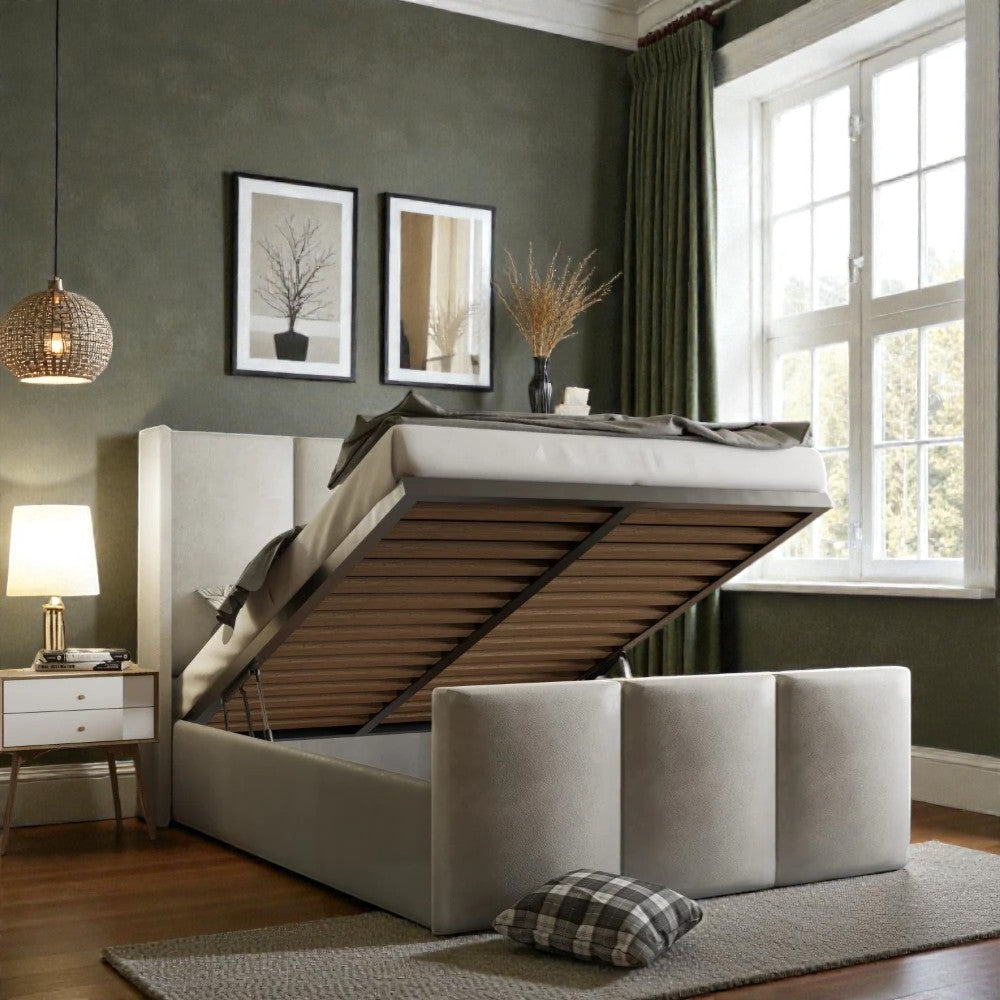 Zaya wingback ottoman storage bed frame with padded headboard and wooden legs, in a modern bedroom setting.