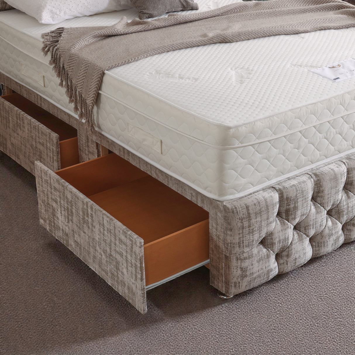 Divan bed set with tall button-tufted headboard and matching footboard, featuring a sleek design for modern bedrooms.