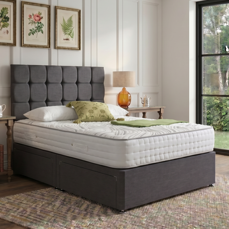 Milan divan bed set with button-tufted headboard and sleek fabric upholstery, shown in a modern bedroom setting.