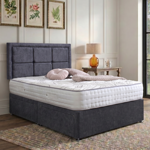 Riga divan bed set with a button border headboard in neutral fabric, showcasing a modern bedroom furniture design.