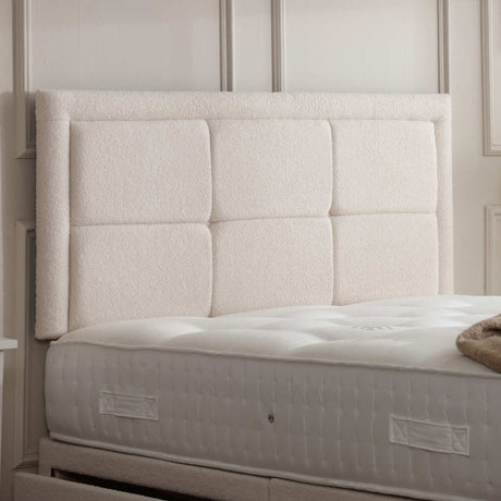 Upholstered Riga button border headboard with plush fabric and elegant design, suitable for a modern bedroom setting.